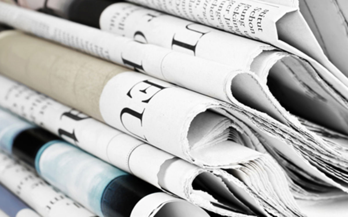 Press releases, news, articles/interviews, press photos/logos Close up of stack of printed and folded newspapers
