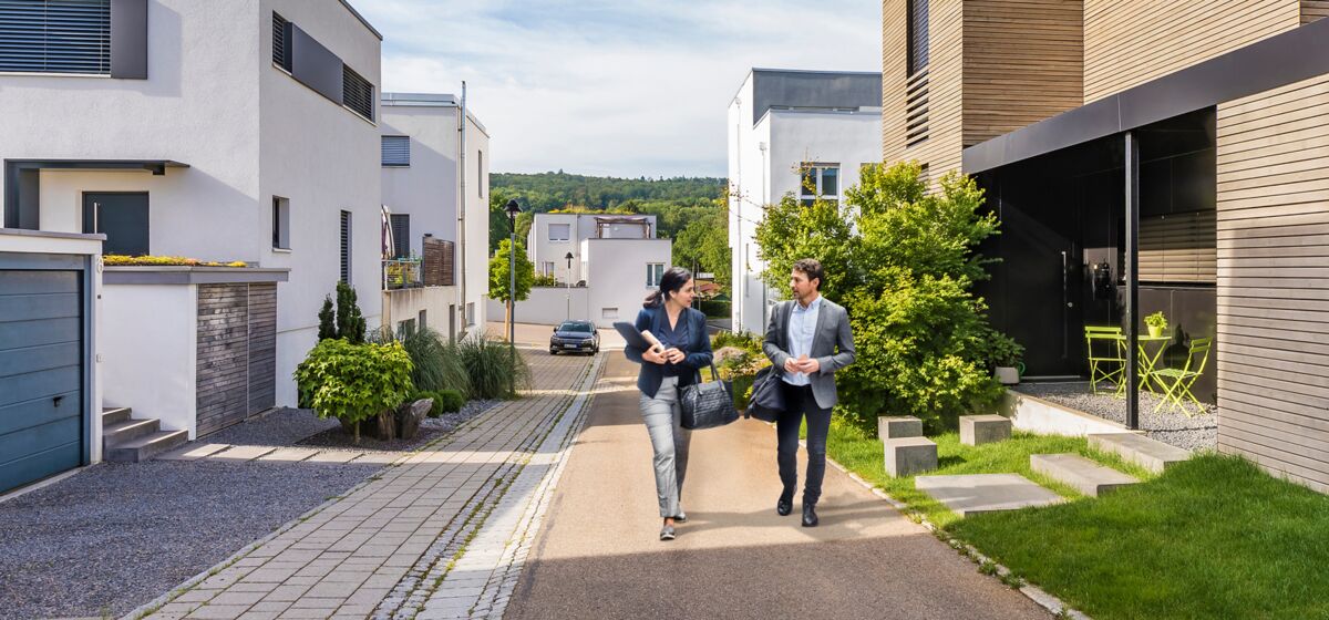 A bank advisor and a man having a talk in a new housing estate