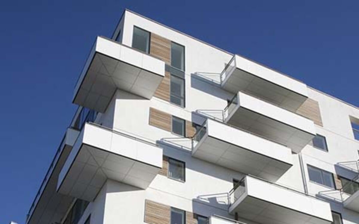 Individual financing solutions in the area of residential use Modern, high-quality, white apartment block with large balconies in the view direction from the bottom to the top