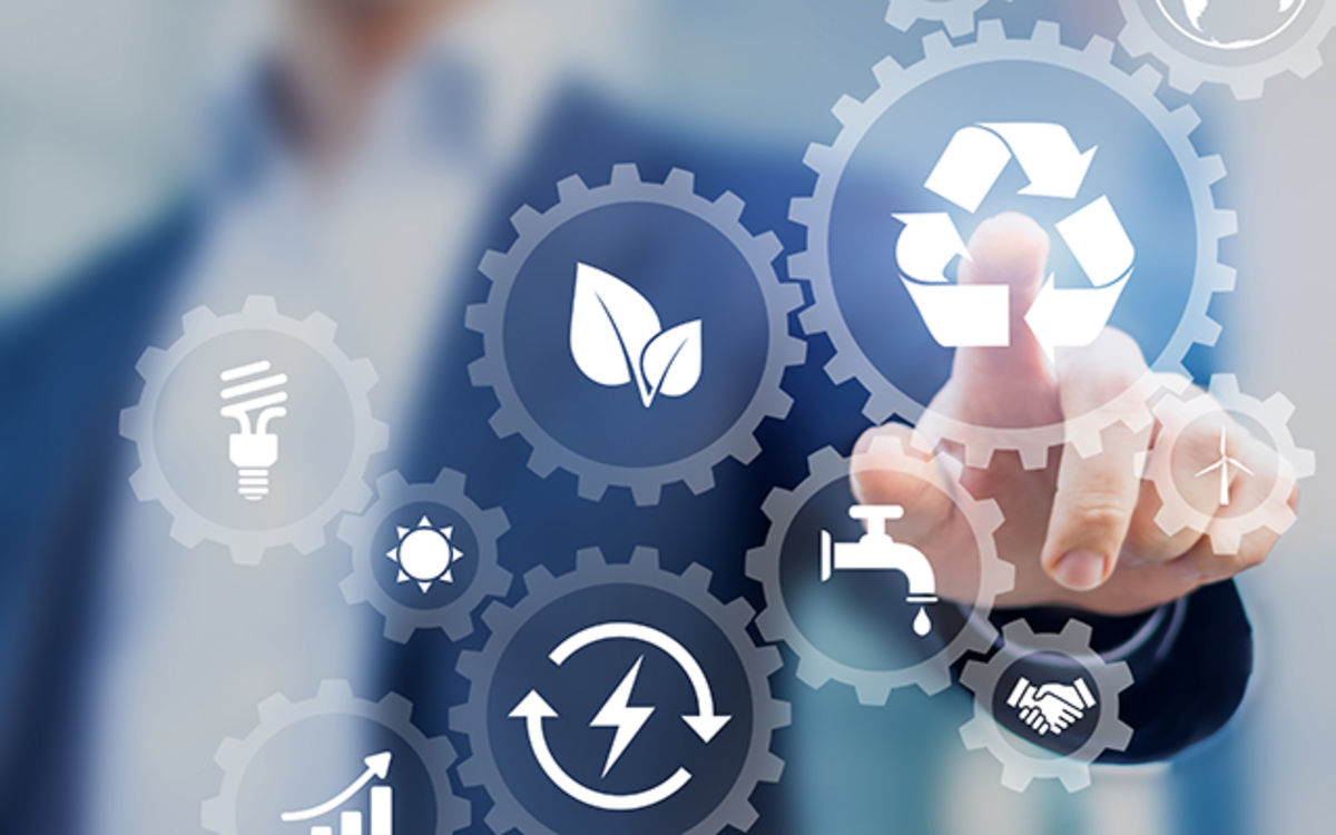 Consistently driving sustainability forward Several overlapping transparent icons with motifs such as leaf, globe, bicycle, windmill, solar panels, etc. In the background blurred shoulder and arm of a real man in suit putting his index finger on the globe icon